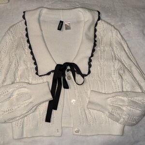 Chic Off White Cardigan with Black Trim